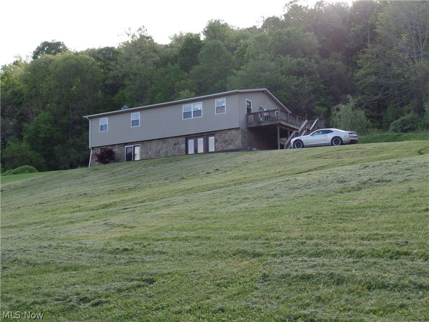 Beautiful, spacious home with an open and inviting floor plan! This three bedroom home features new 3/4" solid hardwood floors and extra large living areas! The lower level has an extra large family room with double French doors that open to a full patio, perfect for entertaining! Outside your will love the 3 car garage with a workshop in the rear!