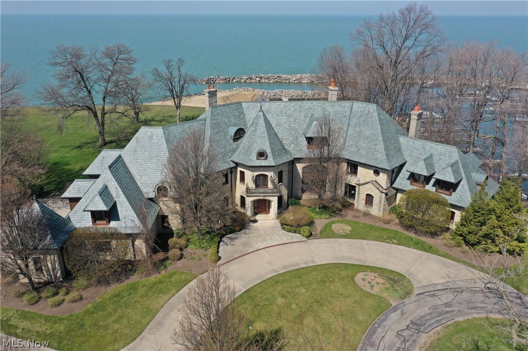 Situated on the shores of Lake Erie this luxurious lakefront estate is truly one of the finest homes in the greater Cleveland area. It’s absolutely incredible and includes a private beach! Exquisite finishes exemplify the top quality craftsmanship throughout. Open floor plan for easy entertaining. Magnificent two story great room overlooking Lake Erie, banquet sized dining room, and a charming library. The remarkable Chef’s kitchen is designed for the most serious cook, and equipped with it all! Breakfast room and a sun room unlike no other. First floor in-law suite with a full kitchen. Gorgeous master suite with a dressing room, and a glamour bath that includes an oversized tub and walk-in shower. Unbelievable lower level with a grand theater, billiards room, exercise room, and a tranquil spa room with a sauna. This home offers the perfect setting for entertaining, outside or in! Upscale gated community. Newport Harbor and the best private club in Northeast Ohio- The Shoreby Club are