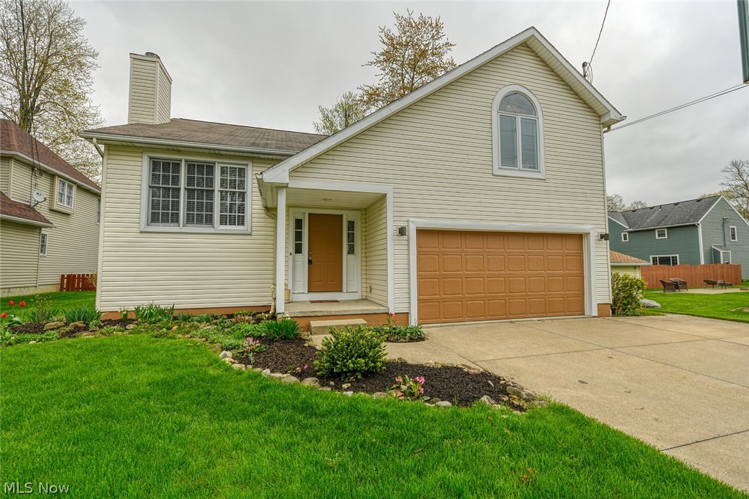 Amazing space in Mogadore! You will have all the room you need, in this 4 bedroom home. Located on a cul-de-sac, with an extra wide driveway and 2 car garage. Enter into the ceramic tiled foyer, where you can also access the garage. Up to the stunning living room with vaulted ceilings and wood burning fireplace. The open floor plan guides you right into the dining and kitchen areas. Beautiful wood floors, vaulted ceiling with sky light and sliders to the deck. The kitchen offers solid oak cabinets, a center island, new range, new dishwasher and refrigerator included. While still on the main floor are the master bedroom, with access to the full bath, 2 hall closets and another bedroom. The most interesting part of the home is up from the living room on the 3rd level. This massive room has a vaulted ceiling, ceiling fan, large windows and a bonus room! This special loft area can be accessed by adding a ladder or steps. Perfect location for an office or secret playroom. Down