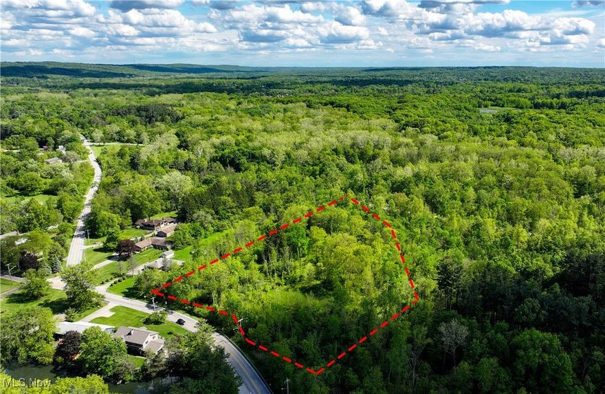 3.18 acres overlooking Mill Stream Run Reservation! Imagine waking up to breathtaking panoramic views of nature, right from your home. Perched majestically atop a gentle hill, this parcel offers an opportunity to create your dream retreat. With sweeping vistas of the Cleveland Metroparks' Mill Stream Run Reservation, this property is a nature lover's paradise. Picture a home, or maybe even condos, strategically placed at the edge of the hill, maximizing immersion in the stunning wooded landscape. Floor-to-ceiling windows would frame the vibrant greens of summer, the fiery hues of autumn, & the delicate beauty of a winter wonderland, where the valley's sculptural contours are revealed in exquisite detail. There's a serene meadow, offering a tranquil space perfect for gardening, recreation, or simply basking in the sunshine. While the former homesite is now overgrown, it hints at the rich history and established presence this land once held. Whether you envision a sprawling single-family home, an artist's studio, or a bespoke retreat, the possibilities are as expansive as the views. North Royalton is renowned for its friendly atmosphere & convenient access to a wealth of amenities. Enjoy a peaceful, suburban setting with easy reach to charming local shops, dining options, & parks. The vibrant local scene offers everything from farmers markets to community events, ensuring you’re connected while still feeling worlds away in your private haven. Explore miles of scenic trails for hiking, biking, or leisurely strolls. Discover hidden waterfalls, observe diverse wildlife, and immerse yourself in the tranquility of nature, all just steps from your future doorstep. Previously home to a residence with electricity & septic, the groundwork for your vision may already be partially laid (buyer to verify all utility availability and suitability for intended purpose). Zoned Residential Vacant Land, this property awaits your architectural masterpiece. Video available online!