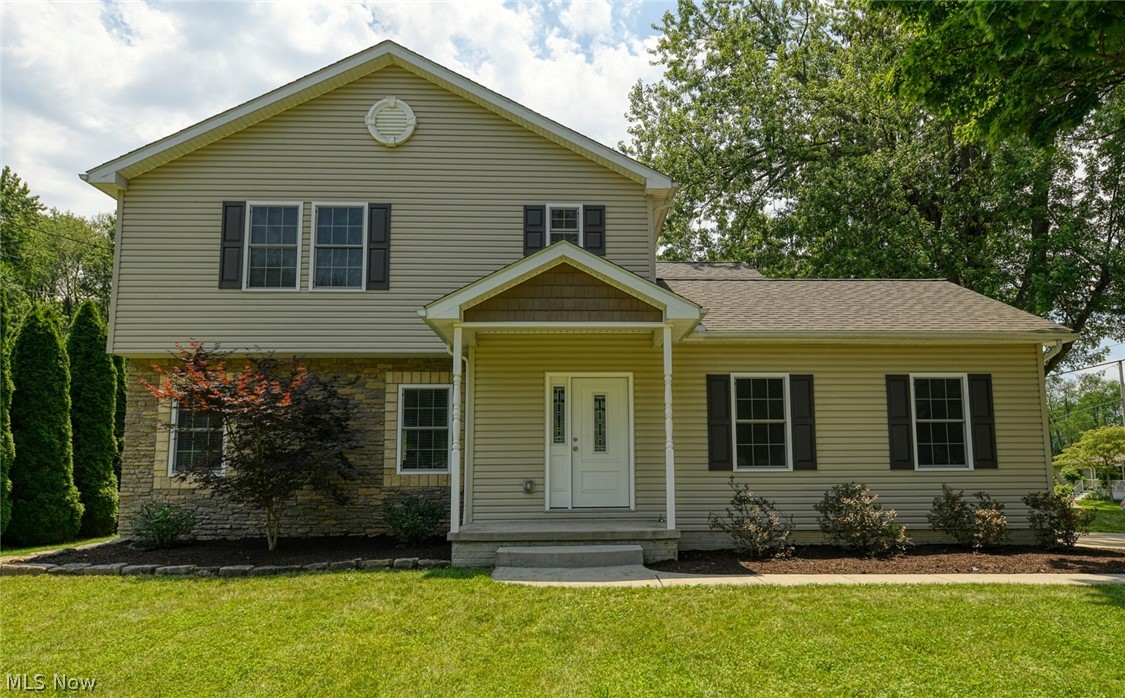 Spectacular open floor plan, four bedroom home in Tallmadge. Situated on a lush corner lot, providing an excellent outdoor space with a front porch, side porch and lovely back deck. This home is just six years old and every part is just like new. From the stunning kitchen with endless granite counter tops, soft close cabinetry, stainless appliances, tile back-splash, massive pantry and beautiful hardwood floors. The wood flooring runs to the dining room, hallway, bathroom, laundry and foyer. The unique serving counter provides an ideal entertaining spot, connecting the guest through the living room, dining room and kitchen. There are sliders from the dining room out to the back deck and large yard. The massive living room offers tray ceilings, recessed lighting and carpet. Down the hall, you will find access to the basement and garage as well as a gorgeous half bath with granite top vanity, a large closet and the laundry room/mudroom, with exterior access to the side deck and y