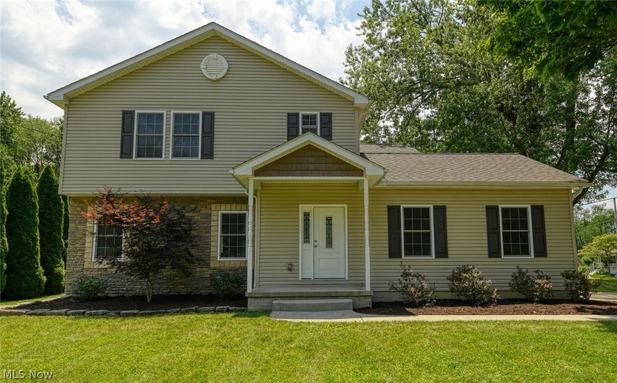 Spectacular open floor plan, four bedroom home in Tallmadge.  Situated on a lush corner lot, providing an excellent outdoor space with a front porch, side porch and lovely back deck.  This home is just six years old and every part is just like new.  From the stunning kitchen with endless granite counter tops, soft close cabinetry, stainless appliances, tile back-splash, massive pantry and beautiful hardwood floors.  The wood flooring runs to the dining room, hallway, bathroom, laundry and foyer.  The unique serving counter provides an ideal entertaining spot, connecting the guest through the living room, dining room and kitchen.  There are sliders from the dining room out to the back deck and large yard.  The massive living room offers tray ceilings, recessed lighting and carpet.  Down the hall, you will find access to the basement and garage as well as a gorgeous half bath with granite top vanity, a large closet and the laundry room/mudroom, with exterior access to the side deck and y