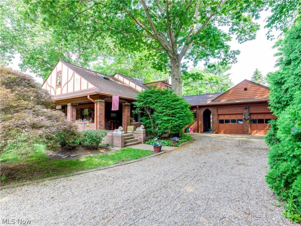 Prepare to be impressed by this stunning all brick Ranch/Bungalow built in 1928 with unsurpassed quality & craftmanship situated on a 1/2 plus acre lot in beautiful Silver Lake Village. This 2800 sq foot home has been lovingly maintained with excellence and careful attention to preserve its many charming and historic features. A welcoming oversized front porch with one entrance into the foyer vestibule leading into the living room and a second entrance through the leaded glass french doors leading into the dining room. From the expansive formal living room and formal dining room you'll find beautiful features that continue throughout the home which include: gorgeous, refinished "heart" pine wood floors, natural wood trim and crown molding, beautiful built in bookshelves in the living room and built in china cabinets in the dining room with leaded glass doors and a wood burning fireplace in the living room with custom designed mantel. The charming, updated kitchen has birch cabinets by Schrock, granite counters with composite sink, new backsplash & a cheerful sunlit breakfast room. The first floor has three generous sized bedrooms, a vintage full bathroom and a fantastic 15 x 15 enclosed sun room surrounded by a lighted deck overlooking the huge backyard with a decorative pond and flagstone walkway and patio. The 800 sq ft second floor encompasses what could be two more huge bedrooms or office or playroom and a second full bath. The basement has a generous sized rec room. Updates include the roof in '19, windows, electric and plumbing. Optional membership at Crystal Lake Park available with an annual fee to swim, fish, paddle boat, paddle board and picnic! Just across the street, available to all Village residents are tennis and pickleball courts, a basketball court, baseball field, children's playground, picnic shelter w/fireplace, kayak/canoe launch, walking trails and the Summit County hike and bike trail.