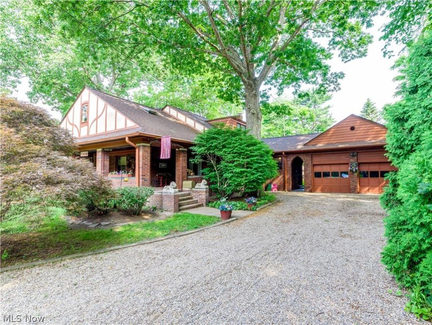 Prepare to be impressed by this stunning  all brick Ranch/Bungalow built in 1928 with unsurpassed quality & craftmanship situated on a 1/2 plus acre  lot in beautiful Silver Lake Village. This 2800 sq foot home has been lovingly maintained with excellence and careful attention to preserve its many charming and historic features. A welcoming oversized front porch with one entrance into the foyer vestibule leading into the living room  and a second entrance through the leaded glass french doors leading into the dining room. From the expansive formal living room and formal dining room you'll find beautiful features that continue throughout the home which include: gorgeous, refinished "heart" pine wood floors, natural wood trim and crown molding, beautiful built in bookshelves in the living room and built in  china cabinets in the dining room with leaded glass doors and a wood burning fireplace in the living room with custom designed mantel. The charming, updated kitchen has  birch cabinets by Schrock, granite counters with composite sink, new backsplash & a cheerful sunlit breakfast room. The first floor has three generous sized bedrooms, a vintage full bathroom and a fantastic 15 x 15 enclosed sun room surrounded by a lighted deck overlooking the huge backyard with a decorative pond and flagstone walkway and patio. The 800 sq ft second floor encompasses what could be two more huge  bedrooms or office or playroom and a second full bath. The basement has a generous sized rec room. Updates include the roof in '19, windows, electric and plumbing. Optional membership at Crystal Lake Park available with an annual fee to swim, fish, paddle boat, paddle board and  picnic! Just across the street, available to all Village residents are tennis and pickleball courts, a basketball court, baseball field, children's playground, picnic shelter w/fireplace, kayak/canoe launch, walking trails and the Summit County hike and bike trail.