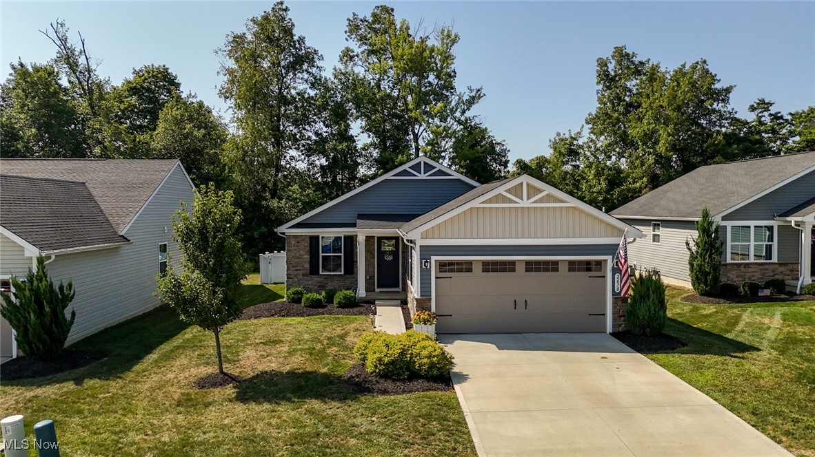 Welcome to this charming, stylish ranch property within the heart of Norton, Ohio. The open-concept design includes beautiful wood floors throughout, a spacious dining room, and a stunning kitchen with rich cabinetry, granite countertops, a large island, and stainless steel appliances, all flowing effortlessly into the bright living area. Sliding doors lead to a full back deck, perfect for entertaining, and a fenced-in backyard ideal for pets or play. Both bedrooms and full bathrooms are beautifully updated with modern vanities and finishes. The full basement offers endless possibilities for storage, a workshop, or future living space. Along with an attached 2 car garage for all your parking needs. Cider Ridge community has a lovely new pavilion for residents that, along with, snow plowing and lawn maintenance make this an extra special community! The thoughtful updates, a warm and inviting layout, and a prime location close to local amenities, parks, and highways, this home is truly move-in ready.