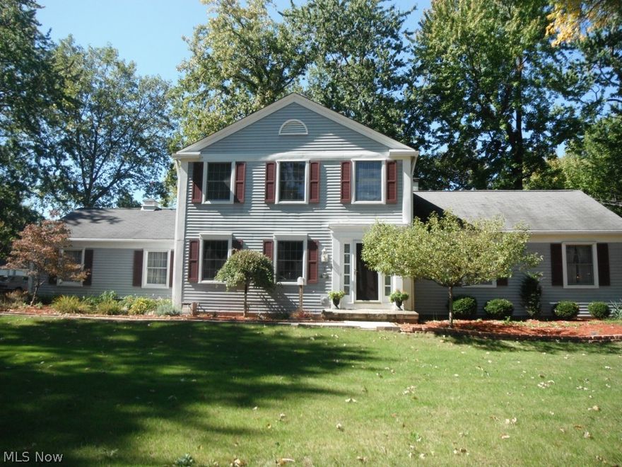 Classic colonial custom built by a builder for himself! Rustic charm combined w/modern elements in the kitchen & family rm. create a warm ambience w/unique appeal! Both rooms boast hickory floors, cedar trim & knotty pine ceiling; family room features fieldstone fireplace, kitchen highlights incl. track lighting, tiled backsplash, Corian countertops, double wall ovens & island w/Jenn Air cooktop! First floor bedroom or den has full-wall built-in bookcases & closet. Spacious master w/walk-in closet, vanity area & full bath. First flr. laundry plus full basement w/2 finished rooms & summer kitchen. Other quality details incl. crown moldings & chair rails, ceramic tile floors in foyer & baths. Two car side-load garage w/hot & cold water & ample pavement areas for multiple car parking. Over a half acre treed lot w/fenced yard, shed & large deck w/removable canopy.Only a short walk to shopping & restaurants!