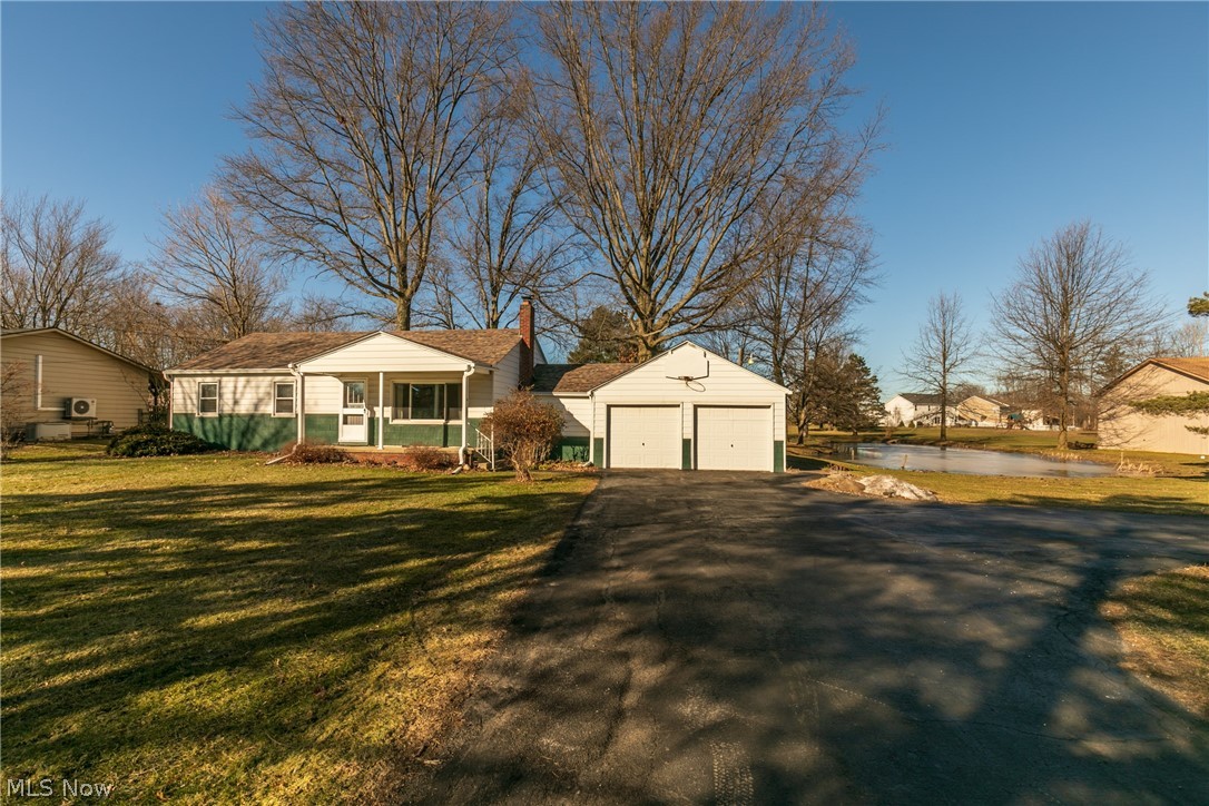 Come see this 3BR, 2 bath ranch-style home on 2 acres in Brunswick Hills Township. Morning sun brightens the Living Room through picture window, while Family Room/Den catches the setting sun. Spacious, remodeled kitchen opens onto a generous composite deck situated under towering oaks with a view of 0.5 acre pond that flourishes with lotus flowers in the summer. First floor laundry room with utility sink and ample storage. Large mudroom connects to 2 car garage with attic. Waterproofed basement with finished main room and 2 additional storage rooms. Home has been freshly painted and carpeted and ready for your inspired design. New roof in 2019. Asphalt driveway with turnaround patched and resealed in 2020. Appliances included. City income taxes do not apply to Township properties.
Lush property is ideal for gatherings, walking or birdwatching with over 40 mature trees, including fruit trees, hazelnut bushes and mature grapevines. Metal-sided pole barn stands in the backyard. Large,