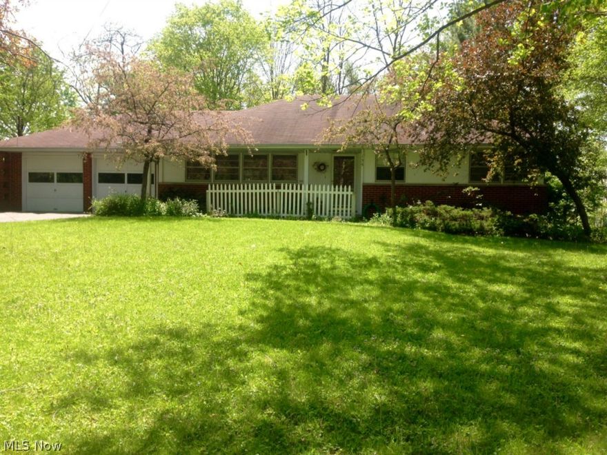 Fantastic location in Chagrin Falls, easy walking distance to the Village! This 2 bedroom ranch with attached 2 car garage has a completely finished lower level with 2 more bedrooms, a full bath and laundry. Perfect for downsizing to one-floor living and still have room for guests! Hardwood floors and plaster walls on the first floor, beautiful traditional fireplace, tile bathroom, pocket doors, lots of windows, coved ceilings and a great sun porch off the living room. The house needs updating and has "good bones" with a solid brick exterior. A manageable yard on .45 acre with a hill in back that provides privacy and long-range views. Awesome potential on one of the most sought after streets in the Village. This is a great opportunity to buy affordably in the best location in Chagrin Falls!