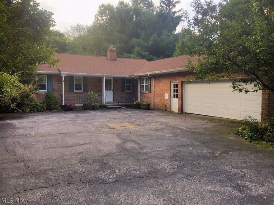 Welcome home to the dream ranch!   This mid century brick ranch is ideally located on SOM with over a 1/4 acre of privacy in the back.   The home features both a soaring ceiling living room and dining room. This is complimented by a cozy family room with fireplace that opens to the charming white eat in kitchen with all appliances included.   Impressive new wood laminate flooring in all your entertaining spaces with new carpet in all the bedrooms.   Master bonus includes it's own private bath.   For ease, laundry is on first floor.  Downstairs is an additional bonus of a finished rec room with carpeting, walk out and additional full bath.  Furnace/humidifier are 2017, AC is 2005 with service contracts included.   This is the greatest value in Gates Mills!