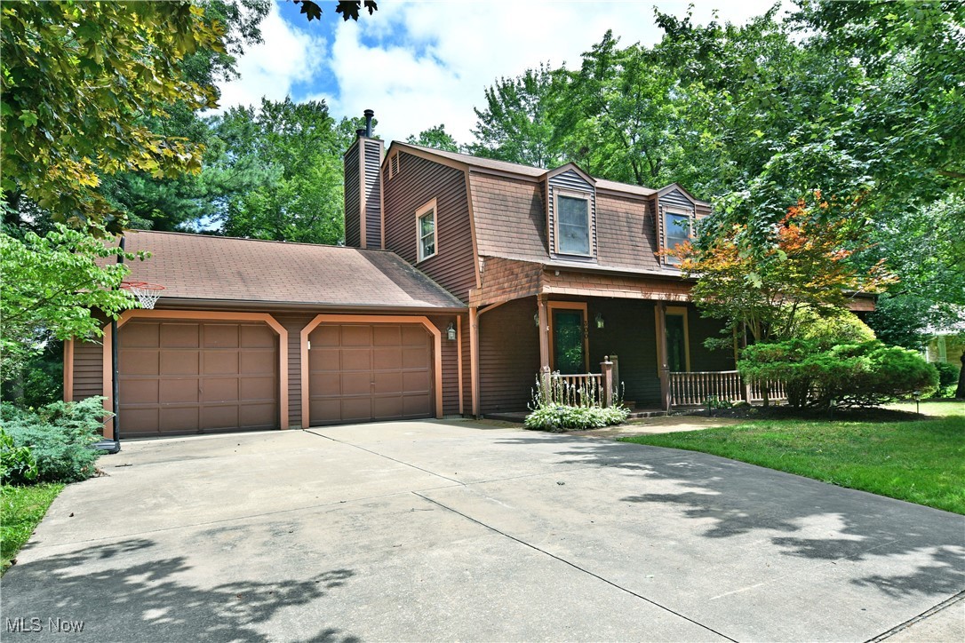 A Cortland delight, this beautifully presenting four-bedroom home showcases two floors of finished living space, brimming with bold colors and plenty of style! Nestled away in a desirable neighborhood just minutes from top local attractions, the residence instantly attracts with its park like setting as tall trees surround the property. A prominent, covered front porch makes the perfect summertime getaway in the shade, while around back a raised rear deck overlooks a burbling creek, and scenic fields found just past the wood line. Step inside to find a gracious foyer trimmed in hardwood styled flooring. A lovely half bath accompanies the carpeted staircase as you make your way into the spacious living room. Around the corner, formal dining room enjoys a wrapping chair rail before transcending into the stunning central kitchen with its rich wood cabinetry and mirrored backsplash. Tiled flooring runs underfoot, offering room for casual dining space. A remarkable family room completes the floor with a must-see brick mantle and its inset fireplace. Entertain with ease as you take advantage of the accompanying wet bar and instant deck access. Upstairs, the four bedrooms branch from the hall offering substantial footprints. They are joined by a full bath at mid hall. The larger master bedroom provides dual closets and its own stylish, full private bath. Laundry, storage and workshop space are found at the basement level. New furnace and central air June 2024. Refrigerator 2023. Seller offering a 1-year home warranty!
