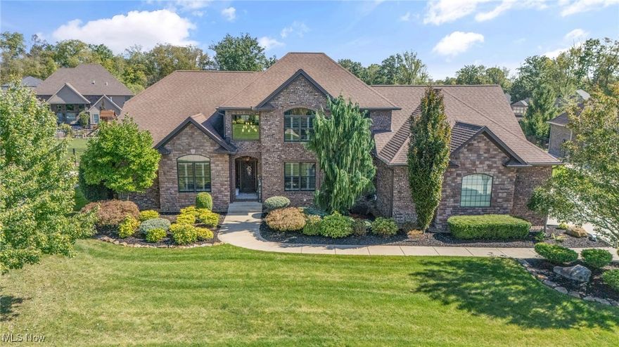 Welcome to your dream home tucked inside a gated community just steps away from the Kensington Golf Club! This place isn’t just a house—it’s a full-on lifestyle upgrade.

Step through the front door and you’ll immediately feel the wow factor: an open-concept great room with soaring 18-foot ceilings and a floor-to-ceiling stone fireplace that screams “cozy nights” and “holiday card worthy.” The dining room comes complete with a dry bar—because let’s face it, entertaining is way more fun when there’s a place for the wine. An elegant first-floor office with a cathedral ceiling makes working from home feel like less of a chore, while the spacious owner’s suite features a spa-like bathroom with a huge ceramic-tiled shower and a separate soaking tub. Translation: your own personal retreat.

The gourmet eat-in kitchen is the heart of the home, serving up style and functionality with direct access to a covered rear patio—perfect for Saturday morning coffee or late-night laughs.

And then there’s the backyard: a heated saltwater pool with a slide, an outdoor bar with a built-in grill, and even a half bath so guests don’t track water through the house. You may never need a vacation again.

The finished lower level is practically a second home—complete with a family room, gaming area, full kitchen and bar, full bath, and a bonus bedroom for those guests who “just can’t get enough of you.”

Upstairs, you’ll find a private bedroom with an en-suite bath, plus three more guest bedrooms and another full bath. Plenty of space for family, friends, or, let’s be honest, a quiet hobby room.

All of this is located in the highly sought-after Canfield School District. Luxury, fun, and functionality—it’s all right here.