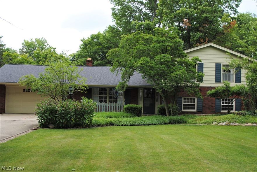 Charming Split level home on a spectacular 87 X 450 park-like lot will impress.  Formal living room.  Eat in kitchen with bay window, hardwood floors and skylight.  1st floor half bath.  Warm family room with wood burning fireplace, built in bookshelves and sliding door to patio.  1st floor laundry room.  3 bedrooms upstairs and a 4th bedroom off the family room.  Boiler heat and central air offers the best of both worlds.  Cedar closet.  Full basement.  Loads of storage throughout the home.  New electric box.  Newer hot water tank.  Roof 2012.  Pella windows.  2 car garage with pull down stairs to attic .  Beautiful yard with mature landscaping offers much privacy.  Call agent today.