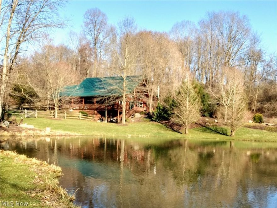 Outstanding opportunity. This property is absolutely amazing. The driveway takes you through paradise and opens to a log cabin custom built in 2002 on 31.8 acres with 3 outbuildings, 3 ponds, 6 acre pasture, 6 acre hayfield and more all just five minutes out of downtown Wooster. The log cabin has a wide open floor plan with gorgeous stone fireplace, first floor laundry, and is completely updated with newer appliances, flooring, roof, furnace and more. Finished basement walks out to a patio, has three additional rooms and safe room. 2750 sf barn/garage workshop has 4 stables, high ceilings, totally insulated with heat, electric, water, extensive second floor hay storage and 2-12x12 & 1-10x10 rear overhead doors with remotes. There is an additional 24 x 30 block outbuilding and a log outbuilding with separate fenced in area. Water hydrants are conveniently located in three separate areas. Extensive updates on all buildings, driveway, pond maintenance, and privately owned gas/oil well, ri