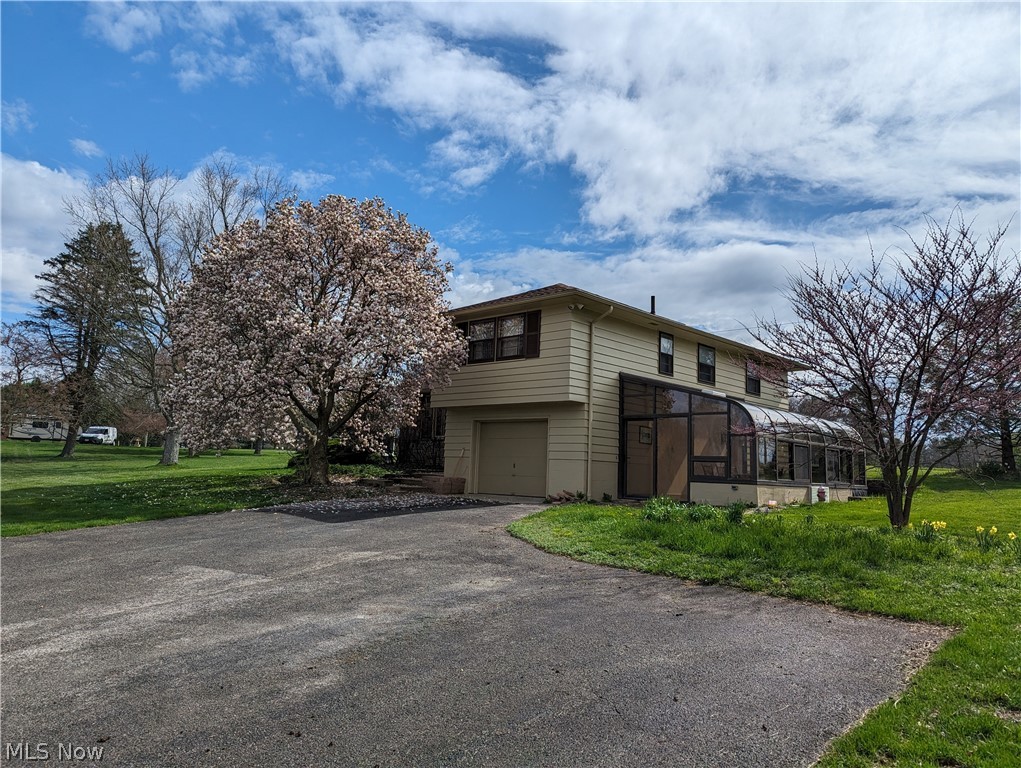 All electric split level home perched on a hilltop with beautiful flowering buds on trees and other mature trees speckled on the 1.49 acre country yard. This home is close to one of the many county parks and a bike trail. You can enter the home through the atrium that is heated and has 3 walls of windows and glass arched ceiling or through the front door that leads into the ceramic tile foyer with large coat closet. The home recently had new carpet in the L -shaped living room and dining room (that wraps around the eat in kitchen that has all appliances and a table in the bay window area) and the new carpet continues from the living room and foyer up the stairs and in the hallway + in the master bedroom. Other features include: a den at ground level between the atrium, garage, basement and kitchen. A couch, loveseat and built in unit is included for use. The master bedroom has a closet large enough to walk in and a small private bath with a shower. The basement has an open room that is great for storage or workshop and includes an upright freezer. Also in the basement is an office room and another room that combines a toilet, sink, washer, dryer, water softener and water holding tank. This home has a full house generater and the 1 car attached garage is 16x20 to allow plenty of room to store your mower and yard maintenance equpment and has an opener. Plenty of more space to park on the paved side parking spots that allow you to still have ample space to pull in and out of the garage. Table and chairs in the atrtrium stays with home. Final work is being done and it should be ready to occupy by May 1st, 2024.