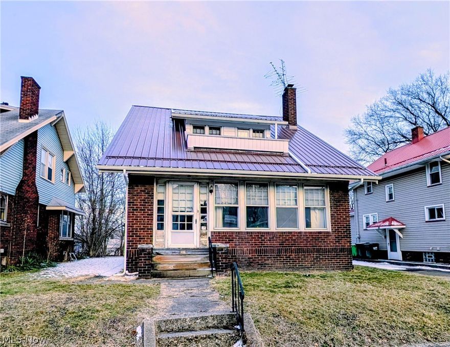 Calling all visionaries and renovation enthusiasts! This solid brick 3-bedroom, 2-full-bath home is packed with potential and ready for its next chapter. A newer metal roof, furnace, and hot water tank provide a strong starting point, while the true charm lies beneath the clutter—original character and classic details just waiting to shine again. Yes, it needs substantial TLC, but with the right updates, this property could be transformed into something truly special. The shared driveway leads to the garage and backyard that stretches all the way to the rear alley, offering added flexibility and space. If you’re looking for a project with great bones, this is your opportunity to bring new life to a timeless home.