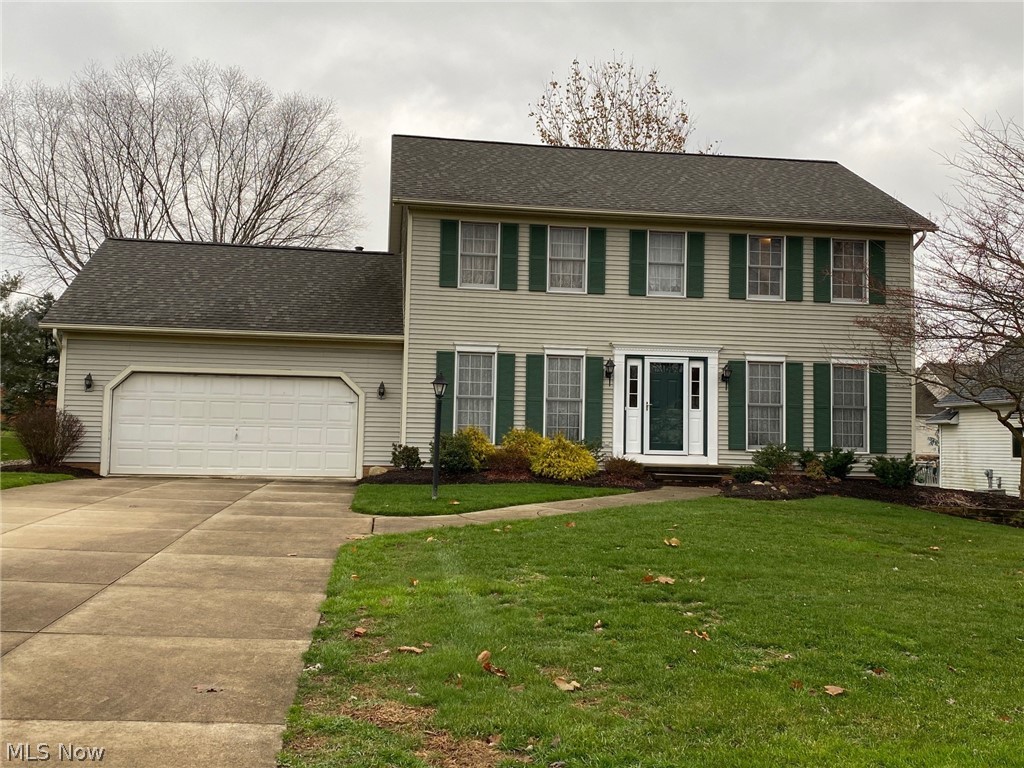 Beautifully kept 4-bedroom, 2-1/2 bath Colonial with open floor plan between gas-fireplaced family room and fully applianced eat-in, updated kitchen with sliders to deck. Original owners have taken great care of this home on a cul-de-sac in Tallmadge Hills. First floor also has formal living room, formal dining room, double coat closet, half bath, laundry room and entrance to attached, deep 2-car garage. Upstairs are four nice-sized bedrooms, including master bedroom with master bathroom and walk-in closet, and main bathroom. Lower level consists of two family rooms, one with wet bar type sink, and storage area with room for desk or work-out area. Updates include roof-4 yrs, A/C-5 yrs, H2O-4 yrs, kitch-2 yrs, basement carpet, some painting. Home warranty included.
