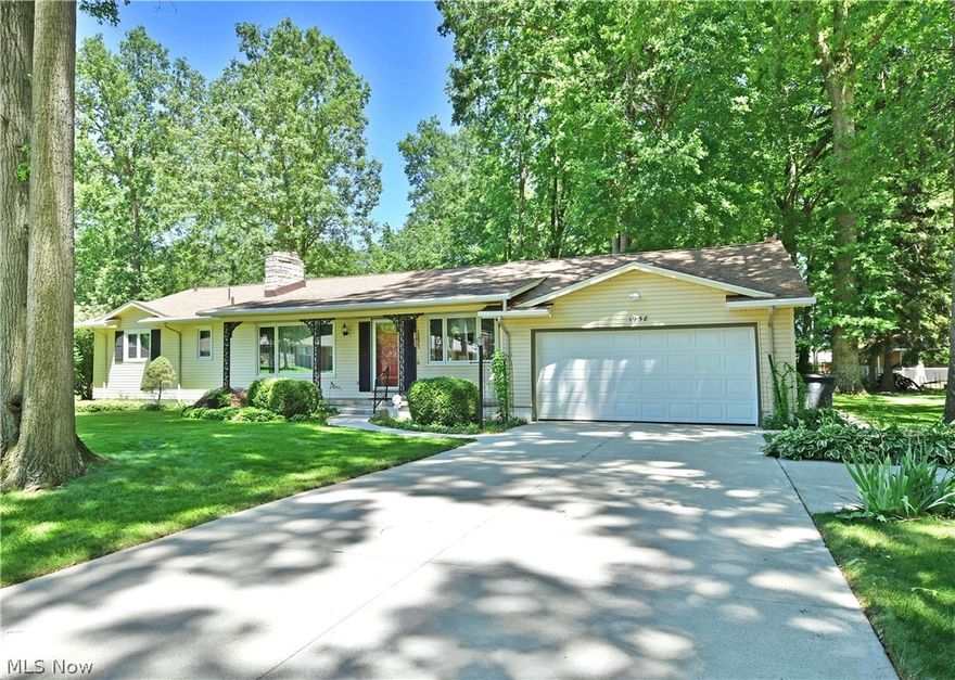 Great Howland ranch in low-traffic neighborhood offers a shady place to call home.  Three bedroom layout with first floor family room, eat-in kitchen + dining room and full walk-out basement with attached garage and concrete drive.  Covered front entry leads to center hall and on to the beautifully updated custom kitchen with quality cabinets and a generous amount of counters.  Dining space overlooks back yard.  Large picture windows  in the living room, dining room and first floor family room.  Fireplaces in the living room and family room.  Architectural details include cove ceiling and wainscoting in the dining room.  Bedrooms are generously sized with plenty of natural light with a full bath dual vanity in the hall and a private bath in the owner's suite.  Access the basement using the staircase with chair lift or through the direct access to the workshop.  Home boasts two complete electrical panels especially updated to power anything you could desire in your workshop.  (Updates i