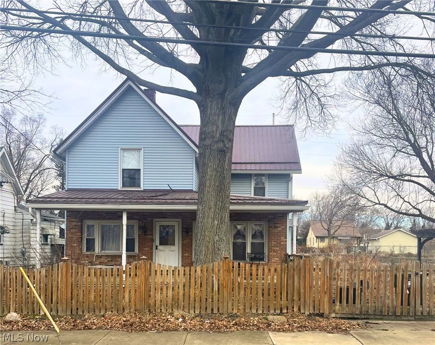 This 2 story, 2 bed, 2 bath frame built home sits on 2 parcels fully fenced in. The home has vinyl siding and a steel roof. The upper level has exterior only access, which needs repair. Being sold as-is with all appliances including 1st floor laundry. There is a full basement that has glass block windows, a newer forced air furnace and a water heater. The first floor has acoustic ceilings, wood cabinets in the kitchen, wood paneling and knotty pine in the den and kitchen and a ceiling fan in the den. The home features a full length covered porch and 45' x 20' 4 car garage with openers and concrete floor. There is access to the garage from both the street and alley.