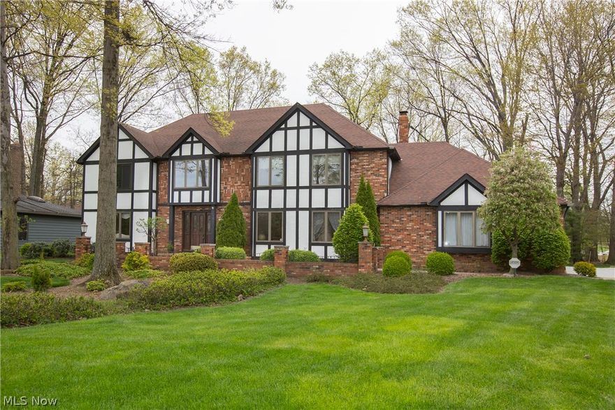 Prepare to be Moved!...into this remarkable Tudor colonial, over 3500 sqft on a nearly ½ acre wooded cul-de-sac lot.  You’ll be greeted by a soaring curved staircase & breathtaking chandelier in the foyer, with a paneled office to the right of the entry.  The elegant formal living & dining rooms are accented with crown molding & chair rail accents.  The bright, cheery kitchen features an island cooktop, double ovens, ample counter & cabinet space & sunny eating area.  Step down into the warm, rustic family room complete with floor-to-ceiling stone fireplace, wood flooring & hand-painted mural surrounding the wet bar.  Triple French doors open onto the deck & lush backyard.  Upstairs, the Master Suite creates a magical retreat with double closets, huge bath with jetted garden tub & separate shower.  Three generously-sized bedrooms share the second full bath.  The fully finished lower level with second wet bar is custom-made for fun & entertaining while still another bonus area would be