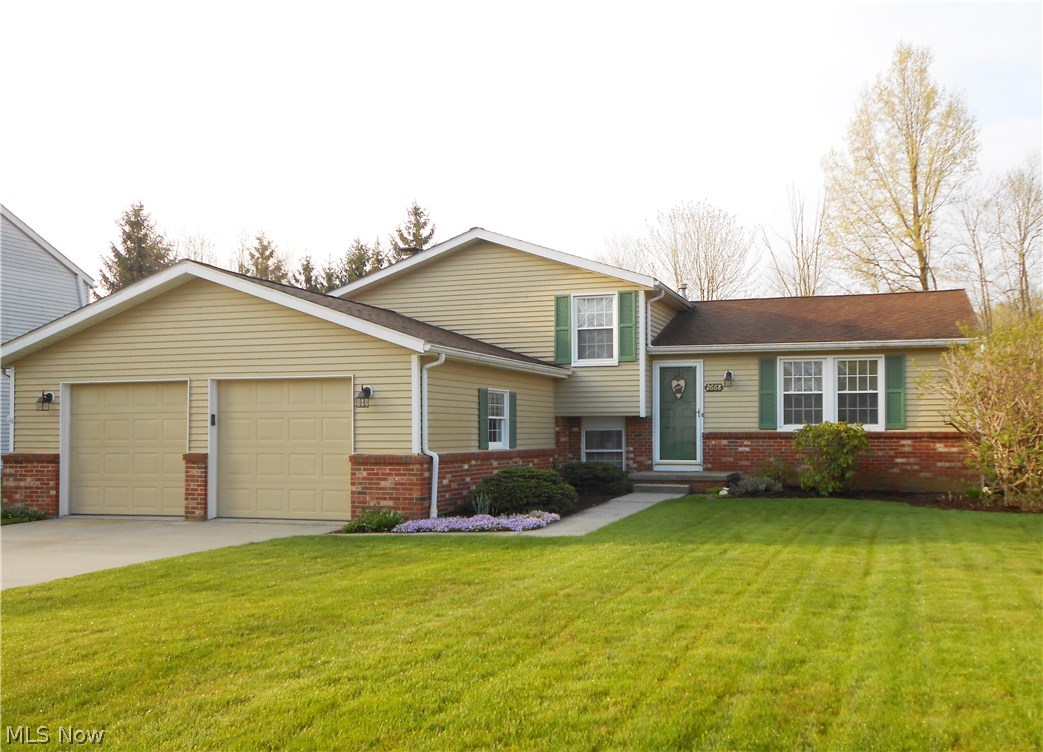 Pride of ownership shows in this beautiful, meticulous home! Kitchen features custom Shrock cherry cabinets with pull out drawers, corian countertops, newer backsplash and breakfast bar. The dining area is open to the kitchen and offers sliders to the 3 season sun room. Outdoors you'll find a lovely brick patio and private backyard. There’s even an electric retractable awning to shade you from the sun. Both bathrooms have been recently updated. The lower level features a family room with gas fireplace, a half bath and a bonus room currently being used as an office. The basement is partially finished offering you more options for additional living space. This home also features newer windows and new living room/dining room carpeting (2016). Looking for extra storage? There’s a 2 ½ car garage PLUS a 24 x 25 outbuilding w/concrete floor and electric.. perfect for entertaining, storage, working on vehicles or any hobby your heart desires. Home is close to park and hike/bike trail