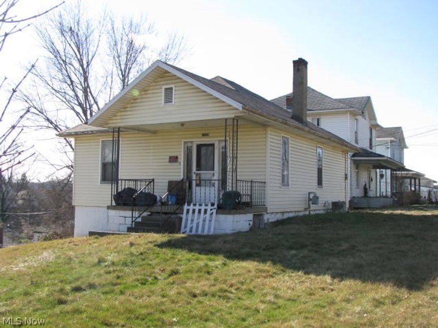 Cute bungalow on a corner lot.  Would make nice rental property, eat-in kitchen w/pantry, decorative fireplace in living room, large front porch, vinyl siding, off-street parking & old garage.  Beign sold "as is" $12.000 MWCD Tax Assessment.