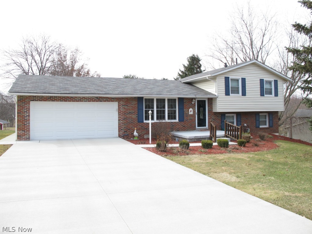 Outstanding value in this 3 bedroom 2 full bath split level that has been meticulously cared for with updates galore. Fully applianced updated kitchen with plenty of oak cabinets and beautiful counter top. Updated bathroom with jetted tub and ceramic tile flooring. New roof and gutters in 2010, updated vinyl windows, new concrete driveway and sidewalks, 90% efficient furnace with central air. The 2 car garage has garage doors on both ends for ease of access and use. Wonderful two tiered deck, great for entertaining or just relaxing, and a new storage shed. No houses behind this one provide for privacy. Don't miss this one.