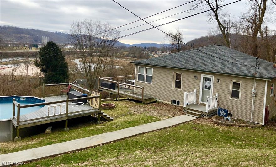 Begin your mornings with a cup of coffee out on your spacious deck overlooking the beautiful Ohio River in this private peaceful part of Rayland, ideally located just off of the Ohio River Scenic Byway.  You'll feel right at home in this ready-to-move-in updated 2 bedroom, 1 bath ranch home with finished basement.  The first floor offers a recently updated kitchen with refrigerator, stove and dishwasher which opens into a very large, newly remodeled living room.  On 3/4 acre, Entertaining options abound with a sunroom, 2 decks or in the 27x13 recreation room which could also be a third bedroom!  Basement has French drains and brand new sump pumps for your peace of mind.  Central Air was added in 2017 to keep you cool on those hot summer days, or you can jump in the pool (2016) with attached deck.  Mineral rights do not convey as sellers do not own them.  Schedule your showing​​‌​​​​‌​‌​​​‌‌​​​‌‌‌​​‌​​‌‌​​​​ today!