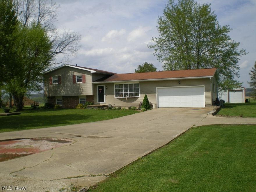 A must see!  3 window air conditioner units, 5 ceiling fans, covered porch in rear, brick patio, 30 x 40 building, propane gas fireplace in family room, large eat-in kitchen.  One of bedrooms is currently being used as walk-in closet. Baseboard electric heat.