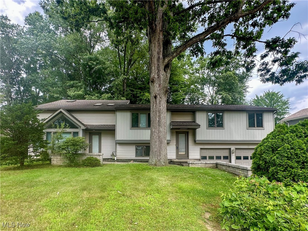 Discover the perfect balance of charm, space and functionality in this exceptional 2,824 square foot split-level residence. With 5 bedrooms and 3.5 bathrooms, this home is ideal for multi-generational living or those who love to entertain. The main level features a welcoming living room and dining area, seamlessly connected to a fully-equipped kitchen. Three bedrooms, including one with an attached full bath, provide comfort and privacy. Another full bath in the hallway caters to loved ones and guests. The highlight of this home is the stunning two-level addition, which features a large great room adorned with cathedral ceilings and skylights that flood the space with natural light. Its versatile open-concept layout can accommodate multiple uses from gaming and media to fitness and study space. A convenient slider leads to the backyard and a separate front entrance allows direct access to this level. On the other side of the home, the lower level provides an office, laundry room and easy entry to the two-car garage. Ascend to the third floor to find two generously sized bedrooms and another full bath. Large windows overlooking the backyard drench these rooms in sunlight. Ample closet space throughout the house ensures that storage is never an issue. Important updates include the roof (2018), furnace (2022), one A/C unit (2025) and hot water tank (2024). The backyard is a peaceful retreat, complete with a deck and plenty of room for relaxation and play. Best of all, this home is located in Howland township, known for its top-notch schools, beautiful parks, popular commercial area and close-knit community atmosphere. Don't miss your chance to experience everything this house has to offer!