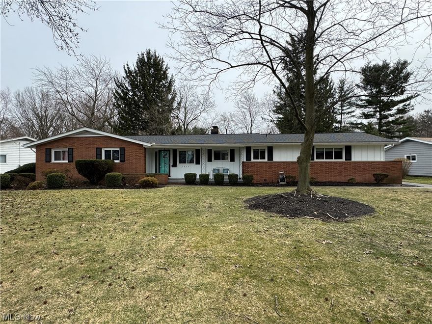 Welcome home to this charming and sprawling ranch home in South Mentor.  Situated on a mature tree lined street with backyard views of Historic Garfield Home, this comfortably sized home features what many Mentor ranches don’t - a full finished basement!  When you drive up to the property, you see the charm of the front porch but when you enter the home, you can see the care and pride of ownership.  Greet your guests in the large foyer that looks into the living room, kitchen, and views of the back yard.  The kitchen offers much countertop and cabinet space and has a Parisian bistro feel with black and white window treatments. All stainless-steel appliances complete the look and stay with the home. The banquette and table also fit perfectly in the space to offer an eat-in kitchen area for your morning coffee or breakfast needs.  Enjoy the ease of first floor laundry room situated right off the kitchen.  The dining room is open to the kitchen, has a slider to the patio and provides you with a lighted storage area.  The living room, in the back of the home, offers views of the Garfield property and a wood burning fireplace. Three bedrooms and two full bathrooms are in the north wing of the home and all three bedrooms provide ceiling fans and nice closet storage.  The primary bedroom en-suite has a standing shower and provides privacy from the rest of the home. The lower level’s main feature is the wood burning fireplace and wet bar.  Not only is there a large, finished family room; there is also a large section for a game room and plenty of storage.  The two-car attached garage is not visible from the curb.  It’s tucked behind the home and can be accessed by a large asphalt driveway and pad for easy turn around.  Enjoy the summer nights on the concrete raised patio or the sandstone patio, this large backyard has much to like! Fine location, near shopping, restaurants, library, park and so much more. Call for a private showing today.