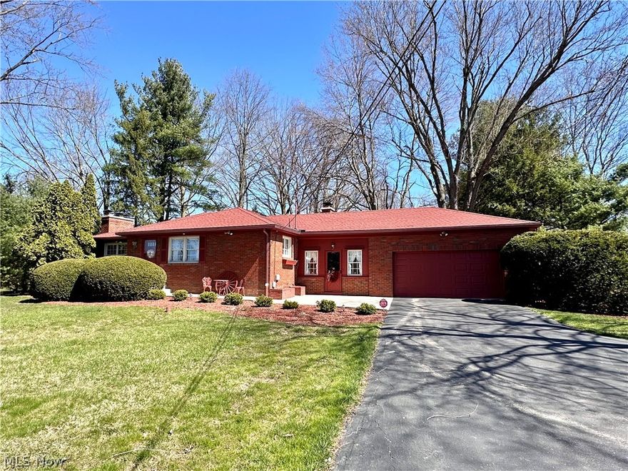 Settle into tranquility while still being within reach of modern conveniences. This well-built brick ranch is ideally situated on two beautiful acres offering a sense of privacy and harmony with nature, yet just a short drive away from shopping, dining, golf/tennis.  the airport and major transportation routes. Step inside and be embraced by the ample living space this home has to offer. From the inviting living room with a brick fireplace and planning desk to the spacious kitchen with breakfast bar and dining area, every corner exudes a sense of comfort and functionality for your everyday living and entertaining needs. Boasting plenty of counter space and updated cabinetry, this culinary haven will serve as the hub for creating delicious meals and unforgettable memories. Down the hall, discover three generously sized bedrooms and a full bath with dual sinks. Prepare to be amazed by the basement rec room, which provides another fireplace and enough space for seating, dining, hobbies and games. It's a versatile place that offers endless possibilities for relaxation and recreation. A laundry room, full bath and storage space can also be found in the lower level. A large enclosed patio that conveniently connects the garage to the house offers a terrific spot for relaxing and enjoying warmer temperatures. The park-like backyard is perfect for outdoor activities and the lush greenery surrounding the house adds to the overall tranquility and beauty of the location. Additionally, this home includes plentiful closet space throughout, updated roof, newer HVAC, long driveway with turnoff and public utilities. Don't miss the opportunity to make this house your own. Contact us today!