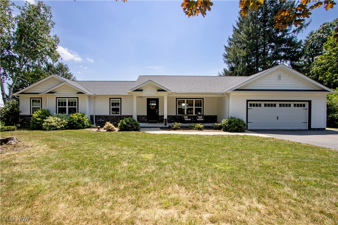 Prepare to be impressed by this beautiful home. Essentially a brand-new build in 2020. From the curb, the crisp white exterior with black trim and a wide driveway sets the tone for the style and quality found throughout the home. A spacious deep two-car attached garage provides plenty of room for vehicles and storage. Inside, you'll find an open concept layout that connects the living room and kitchen, perfect for everyday living and entertaining. The living room features a cozy fireplace, while the kitchen boasts a large island, sleek stone countertops, and space for a dining table. Just off the kitchen, sliding doors lead to a great back deck with an incredible view, ideal for relaxing or entertaining. A large laundry room is conveniently located off the kitchen near the garage entry and offers ample space for organization. The main level includes three bedrooms and two full baths, including a lovely primary suite with a private bath. The lower level is partially finished, providing a flexible family or recreational space, along with a full bathroom and abundant storage options. The backyard is generously sized and adds to the home's appeal. Situated just minutes from the conveniences of Orrville, this move-in ready gem offers the perfect blend of modern style, comfort, and location.