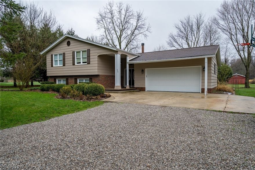 WOW! Pristine split level in Franklin Township on 2.5 acres!  Close to golf course.  This gorgeous lot backs up to the bike path and features creek, storage shed, & a huge 24'x36' outbuilding!  Back patio is Nature Stoned and features a Pergola.  Exterior features cement siding (no peeling and no dents form hail) and brick.  The front porch is also Nature Stoned & welcomes guests to your double entryway leading into your new home.  With over 2,300 square feet of living space you will have plenty of room to entertain your favorite guests -- inside and out!  This split features 4 bedrooms and 2 newly remodeled full bathrooms.  Upper level features beautiful hardwood flooring throughout.  Spacious living room with a gorgeous wood-burning fireplace flows into the dining room, which then flows into the kitchen.  Kitchen features ceramic floors, island, & hickory cabinetry.  The walk-out lower level features an in-law suite with newer carpet, a family room with electric fireplace, and rear p