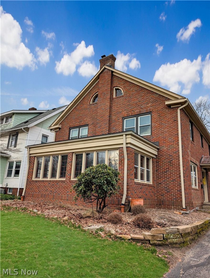 Celebrating its 100th year, this distinguished 1926 brick Colonial stands as a true century home, blending the craftsmanship of a bygone era with thoughtful modern updates across 3,706 sq. ft. of finished above-grade living space. A gracious foyer with a turned staircase introduces the home’s timeless character, leading to an elegant formal living room with a classic fireplace and an inviting library enhanced by custom built-ins. The sun-drenched four-season room expands the living space and offers tranquil views of the grounds. A formal dining room flows seamlessly into the updated kitchen, featuring granite countertops and maple cabinetry, with a convenient half bath nearby. The second floor hosts four spacious bedrooms, two full baths, a charming solarium, and a dedicated laundry room. The expansive third floor provides a private bedroom suite complete with a sitting area and full bath—ideal for guests, extended family, or a quiet retreat. The lower level offers abundant storage. Exterior amenities include a two-car attached garage plus an additional detached one-car garage, a deck with pergola, raised garden beds, and a peaceful backyard perfect for enjoying nature. Ideally situated near the vibrant shops and restaurants of Highland Square, this rare century home offers historic elegance, modern comfort, and enduring appeal