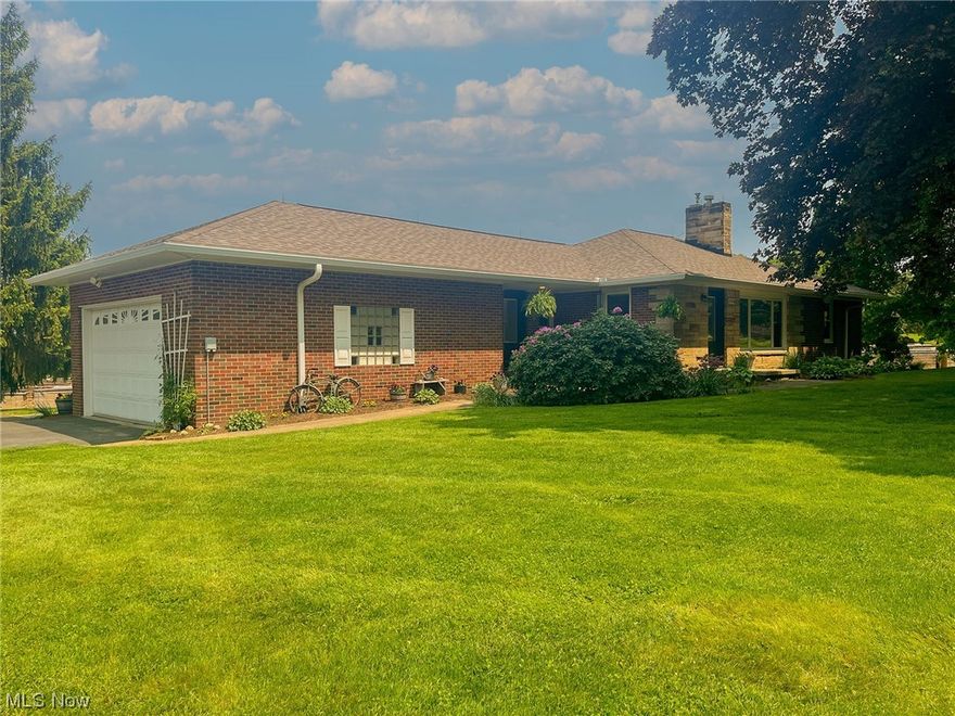 Auction: June 20th at 6 PM. Located between Kidron and Dalton, this home offers splendid views of the Sugarcreek valley. Built in 1954, this brick home has been thoughtfully updated in recent years, ensuring a comfortable living experience for years to come. Situated on a 1.4-acre lot, there is ample yard space, and an additional 3/4 acre adjoining to the south can be rented for those in need of pasture space for animals.
As you step inside, you'll be greeted by a modern open floor plan and tasteful laminate flooring that flows seamlessly throughout the main area. The eat-in kitchen boasts a hickory island that contrasts nicely with the white custom cabinetry, Corian® countertops, and a suite of newer kitchen appliances-all included in the sale. The living room, featuring a cozy gas insert fireplace, provides a perfect space to relax. The main floor encompasses two bedrooms, a bathroom, and a convenient laundry area. The walk-out basement level offers even more living space, with an a