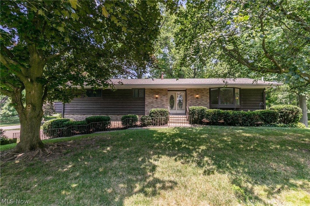 Welcome to this charming raised ranch that has over 2,000 sq ft of living space in Stow. Large family room with a beautiful bay window that allows for the sun to shine in. The living room also boasts a vaulted ceiling and an electric fireplace for those cold winter nights. A sizeable kitchen with adjoining eating area, with tons of cupboards for storage, and also a nice island for sitting. From the kitchen step out to the enclosed three season room overlooking the backyard which makes a perfect spot for relaxing. There are 3 generously sized bedrooms and 2.5 baths. The master bedroom has an ensuite bathroom and walkout deck. The lower level of this home has a completed finished area, perfect for a kid’s rec room, man cave, or second living room and walks out to a covered porch and patio that is perfect for all your entertaining. Additional bonus to this great home is the fantastic 3 car garage and extra storage shed on this large wooded corner lot!