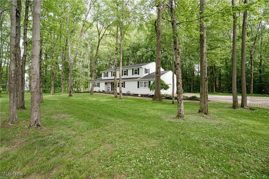 Welcome to 4484 Ranchwood Spur – This beautiful Colonial offers timeless elegance, thoughtful updates, and a peaceful wooded setting in the sought-after Revere School District. Step inside to discover the warmth and character of historic reclaimed, barnwood floors that flow seamlessly through the living room, family room, and formal dining room. The inviting foyer opens into a spacious, light-filled living room, accented with recessed lighting. Across the hall, the formal dining room provides the perfect backdrop for memorable dinners and gatherings. The kitchen features new slate tile flooring, a charming brick backsplash, rich hardwood cabinetry, newer appliances, and a cozy eat-in nook with sliding doors that lead to the back patio—ideal for everyday living and effortless entertaining. The heart of the home, the family room, boasts a striking brick accent wall with a fireplace and another set of sliding doors, creating seamless indoor-outdoor connectivity. A slate-tiled laundry/mudroom offers generous built-in cabinetry and conveniently connects to a private home office and an additional full bath on the main level for extra family comfort. Upstairs, you'll find four spacious bedrooms with fresh carpeting. The primary suite includes a large closet and private ensuite bath, while the recently renovated shared full bath adds both style and function for the additional bedrooms. The newly partially finished basement extends the living space with a versatile rec room and bonus room, both finished with durable luxury vinyl plank flooring. With direct stair access to the attached garage, this lower level adds flexibility for daily living. Outside, enjoy a tranquil setting with a newly installed patio, wooded views, and a charming trail that leads to a secluded fire pit— perfect for evening relaxation. Other improvements include a new roof  and gutters (2023) and a new AC condenser (2022). Don’t miss your chance to own.