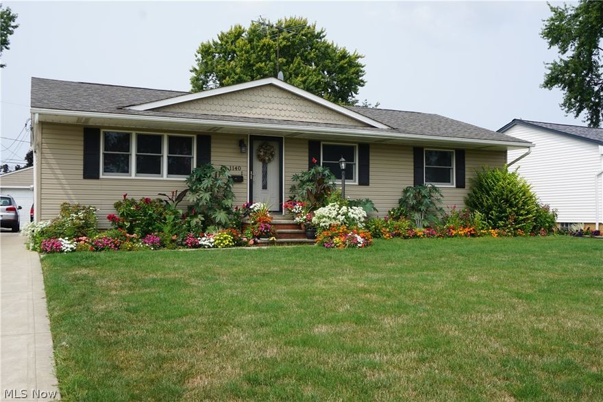 Everything you want in a home. From the remodeled kitchen with large dinette complete with Refrigerator, stove, and dishwasher, large dinette open to the living room. The large 19 foot living room has  beautiful hardwood floors. In the main portion of the home there are 3 bedrooms and 2 full  baths. All with a fresh coat of paint. In the rear of the home is an in-law or teen or master suite complete with private bath, the 4th bedroom, 3rd full bath, kitchen, and living room dinette combination. Privacy plus with the  Suite in the rear of the home having  its own entrance. There are actually 2 master suites in this home! Going downstairs there is a 23 x 21 foot rec room for all your entertaining or just plain relaxing. Also a separate laundry area, and a separate serving/preparation room. The detached 2 car with gardens behind finish off its beauty. Just look at the beautiful flowers surrounding the home. Did you say curb appeal – YES.