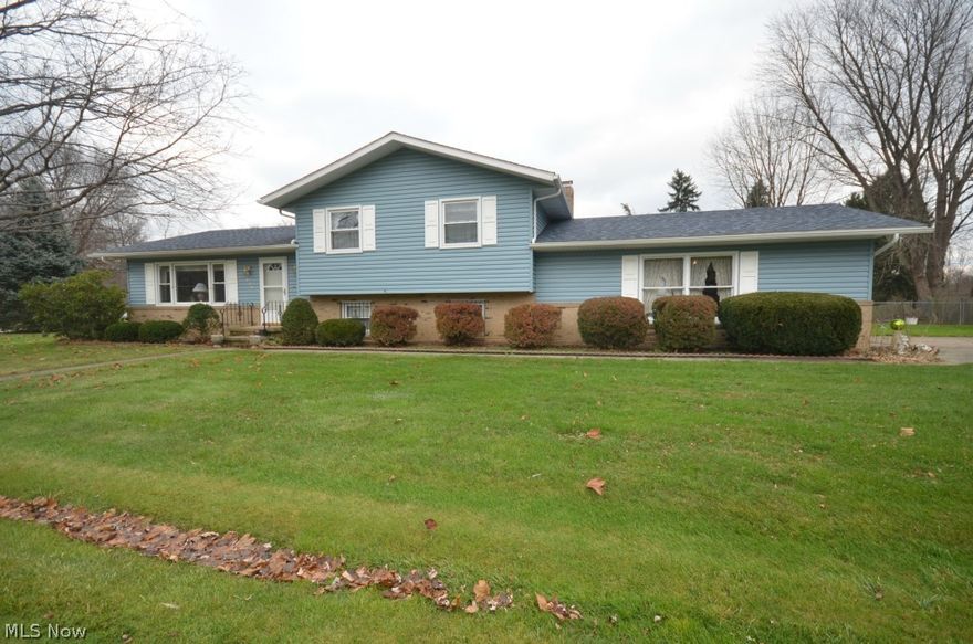 Fantastic Tallmadge Opportunity! Many big tickets already updated, large square footage and the chance to update cosmetics to make this great home your own! Enter to the living rm with cathedral ceilings through to the dining room- large picture window in the living rm and sliding glass door off dining rm to patio out back. Spacious eat in kitchen w vaulted ceiling & view to lower level. Upstairs features 3 bedrooms plus a big full bath w private commode & shower/tub area plus a big linen closet and laundry chute. Master bedroom w 2 closets (1 large closet & 1 cedar closet). Lower level family rm w big stone woodburning fireplace plus bedroom #4/office, laundry rm w utility sink & built in cabinets plus another full bathroom! The basement is partially finished- and makes a great rec room space. Updated include ’12: Dimensional Shingle Roof, Vinyl Siding, Gutters, Downspouts, Garage Door, Opener. ’06 Furance w AprilAire humidifier. Additional Updates: Windows (dual pane vinyl tilt-in w