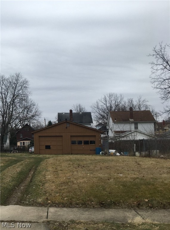 Two parcel vacant lot with two car garage on one parcel and chain link fence around second parcel. Currently used for a garden by neighbors (have permission).