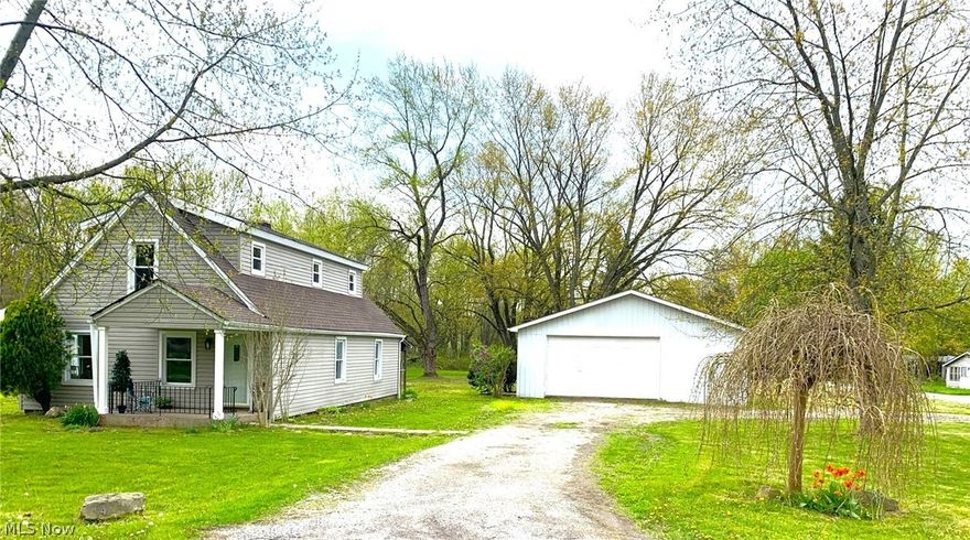 Have you been dreaming of a country cottage?  It's finally here!  Newly installed laminate throughout, all freshly painted, new furnace, a/c, roof, bathrooms and installed city water.   Cute as a bug!  Comes with 4 lots with the house situated on a corner.  You will love this huge 40x32 garage with concrete floor and electric.  The garage is great for storage or working on projects and if you have pets or kids, you will love the huge, treed back yard.  Nice back porch and room on front porch for a swing!  Hurry, this one won't last.