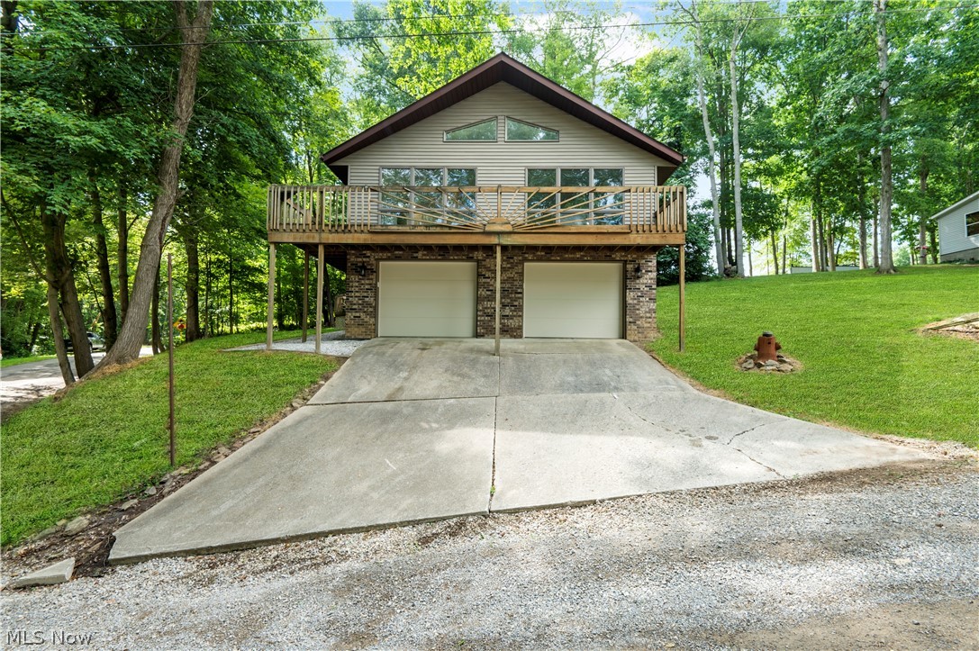 Privately owned home/land in Atwood Lake Region, minutes from the lake. This beautiful and recently updated A-frame home is spacious, bright, and airy with abundant natural light. -Great room with a cathedral ceiling, large front windows with great views, and an open floor plan to the kitchen. The eat-in kitchen is entirely new with stainless appliances, white cabinets, laminate floors, a breakfast bar with solid surface countertops, a pantry, recessed lights, subway tile (to be installed), and a dinette area with beautiful views. The main floor is complete with two bedrooms (with large closets), a full bath, a linen closet, and new laminate flooring. The lower level/basement is bright & clean, with a laundry room, a bonus room, and walk out to the heated two-car garage. -Two large decks front and back. Updates include fresh paint, new water heater, new baseboard/trimming, new toilet & vanity/sink, new hardware & light fixtures, new doors/locks, new garage doors, etc. 700 ft from the r