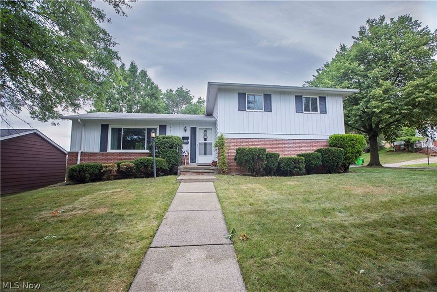 A spacious 3 bedroom, 1.5 bath split level on a large corner lot! Enter through the front door and you will immediately appreciate the large living room with a picture window and plenty of natural light. Down the hall is the eat-in kitchen, which opens to the dining room on one side, with sliders to the large back patio, and through to the lower level family room on the other; the perfect gathering place for family and friends! The laundry room, half bath, and access to the attached 2 car garage complete the lower level of this fantastic family home. On the second floor you will find 3 generous bedrooms, each with hardwood floors, and a full bath.  Additional highlights include a new hot water tank (Dec. 2018), newer windows, A/C, driveway, and roof; sidewalk repairs; an updated 100 Amp electrical box; freshly power-washed exterior; and fresh paint on every wall and ceiling in the house as well as the eaves on the exterior. Located only 20 minutes from everything in Downtown Cleveland