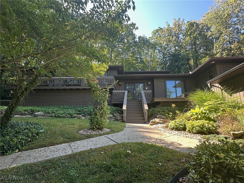 This stunning home located on the highly desirable Beachwood Island in Twin Lakes is sure to impress! Featuring 3,272 sq. ft. of interior living space with multiple decks, outdoor fireplace, built-in gas grill, and many high-end updates this home is an entertainer's dream! Enter through the large inviting foyer and you will find a family room and living room both with warm cozy fireplaces; a full bath; gorgeous eat-in kitchen with concrete countertops, modern Kraftmaid cabinetry, stainless steel appliances, and LVP flooring; formal dining room with deck access; sunroom with deck access; an additional dining area; walk-in pantry with ample storage; 1st floor laundry room with folding desk, abundent cabinetry, built-in ironing board, and stainless laundry sink. For the wine enthusiasts there is an incredible wine room located off the kitchen with racking that can hold approx. 335 bottles plus two beverage refrigerators. On the second level you will find the bedrooms and two bathrooms including the large primary with private deck, en-suite bathroom and huge walk-in closet. The second bedroom is currently being used as a large home office but could easily be converted back into, not just one, but two bedrooms. The third level offers a massive loft area with built-in desk, cabinetry and closet and is currently being used as an exercise room/bonus room, but could be made into an additional bedroom. Exterior features include: the 2-car attached garage, heated with hot and cold water and epoxy floors; an expansive back deck with built-in grill and fireplace, perfect for entertaining from summer through fall; and a small storage shed for the trash and recycling receptacles. Additionally, there is exclusive lake access and privileges including swimming, boating, picnic pavilions, restrooms/changing rooms, and lifeguard, so you can spend your summer at the beach! This remarkable property has tons of recent upgrades and improvements. Schedule your appointment today!