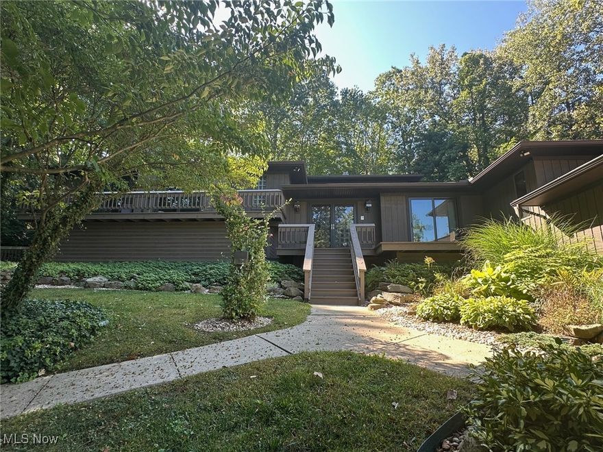 This stunning home located on the highly desirable Beachwood Island in Twin Lakes is sure to impress! Featuring 3,272 sq. ft. of interior living space with multiple decks, outdoor fireplace, built-in gas grill, and many high-end updates this home is an entertainer's dream! Enter through the large inviting foyer and you will find a family room and living room both with warm cozy fireplaces; a full bath; gorgeous eat-in kitchen with concrete countertops, modern Kraftmaid cabinetry, stainless steel appliances, and LVP flooring; formal dining room with deck access; sunroom with deck access; an additional dining area; walk-in pantry with ample storage; 1st floor laundry room with folding desk, abundent cabinetry, built-in ironing board, and stainless laundry sink. For the wine enthusiasts there is an incredible wine room located off the kitchen with racking that can hold approx. 335 bottles plus two beverage refrigerators. On the second level you will find the bedrooms and two bathrooms including the large primary with private deck, en-suite bathroom and huge walk-in closet. The second bedroom is currently being used as a large home office but could easily be converted back into, not just one, but two bedrooms. The third level offers a massive loft area with built-in desk, cabinetry and closet and is currently being used as an exercise room/bonus room, but could be made into an additional bedroom. Exterior features include: the 2-car attached garage, heated with hot and cold water and epoxy floors; an expansive back deck with built-in grill and fireplace, perfect for entertaining from summer through fall; and a small storage shed for the trash and recycling receptacles. Additionally, there is exclusive lake access and privileges including swimming, boating, picnic pavilions, restrooms/changing rooms, and lifeguard, so you can spend your summer at the beach! This remarkable property has tons of recent upgrades and improvements. Schedule your appointment today!