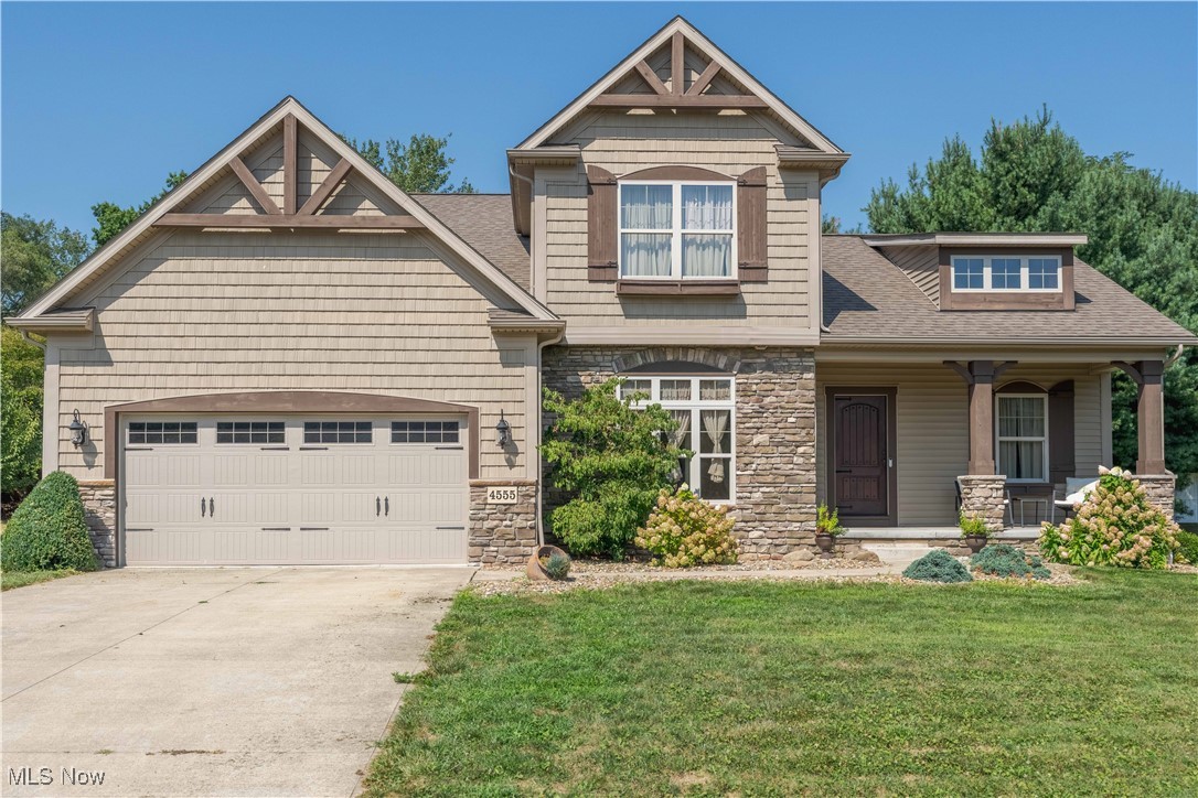 Welcome to this stunning custom-built Craftsman-style home nestled in the highly sought-after Century Village community in Jackson Township. Offering 4 spacious bedrooms and 2.5 baths, this home combines charm, comfort, and functionality. You'll be greeted by impressive curb appeal, with a welcoming covered front porch and a covered rear patio overlooking a private, tree-lined backyard—perfect for relaxing or entertaining. Inside, the expansive first floor features an oversized great room that flows seamlessly into the eat-in kitchen. The kitchen is a chef’s dream with a large granite center island with breakfast bar, dinette area, stainless steel appliances, and premium soft-close KraftMaid cabinetry. Additional first-floor highlights include a cozy private office, a convenient half bath, a laundry room, and a luxurious primary suite. The primary suite boasts a granite-topped dual vanity, soaking tub, walk-in closet, and a beautifully tiled walk-in shower. Upstairs, you’ll find three additional bedrooms and a full bathroom. The full unfinished lower level offers high ceilings and is already plumbed for a bathroom, presenting a fantastic opportunity to add a recreation room, home gym, or additional living space. Don't miss your chance to own this beautiful home in a prime location close to shopping, dining, and top-rated schools.