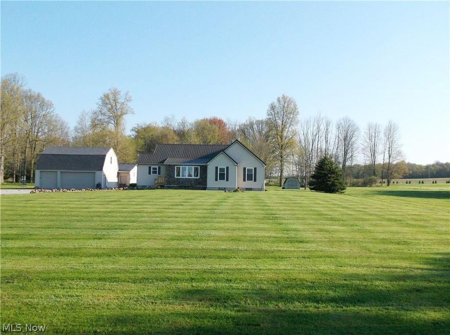 This Well constructed Ranch home on  5+ Acres   has Great interior and exterior Workmanship.  Hardwood floors, in the Kitchen and Dining area, and Great room that also has wood beams as part of the vaulted ceiling.  The open space has lots of light from the Beautiful stone faced Bay window for the WOW factor, different lighting to accent this space.  New carpeting in 2 of the Bedrooms while the Master Bedroom still has the hardwood floors.  There are updated Bathrooms and a partially finished Bedroom in Basement. The Basement of 13 block high-has the  remaining area as a Blank canvas for any type of finished work.   New Stainless Steel appliances.  Relax and Enjoy the Peace on the full length back Porch or stone/brick Patio and much more!  With the 6 Car Detached Garage that 3 of the Bays have Heated floors and insulated ceilings with a walk up storage area that can be finished as one chooses.  The 5.1 acres is a major plus.