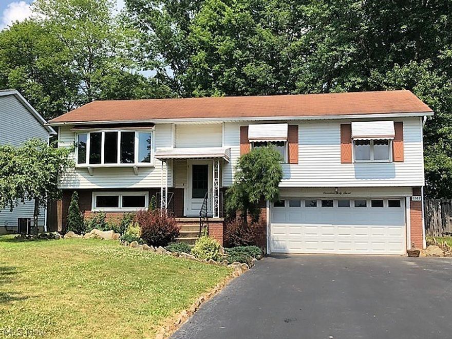 This one owner bi-level in Mineral Ridge is ready for a new owner.  Nice landscaping and wide drive with 2 car attached garage with room for storage.  Newer wood laminate flooring in living, dining, kitchen and hall.  Could easily be added to bedrooms and family room.  Newer solid oak railing, banister and baseboards.  Large bay window seat in living room.  Dining room has beautiful sliding glass door which opens to multi-level deck.  Large fenced backyard complete with wood privacy fence and fire pit which would be perfect for swimming pool, dogs or kids.  Bathroom features ceramic tile flooring. OWNER OFFERING $1000 FLOORING ALLOWANCE WITH ACCEPTABLE OFFER.  Home is just waiting for new owner!