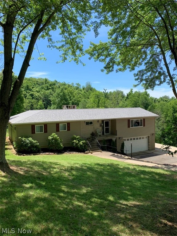 ATTENTION BUYERS! This is a RARE listing! Built in 1979, this home has been much loved by the same family for over 40 years and is ready to begin a new chapter with you! This LARGE home in a PRIVATE SETTING has a total of 4 bedrooms and 4 bathrooms- a rarity in itself. All four bedrooms are very comfortable in size, have ample closet space and newer carpeting. The master bedroom is generously sized and has newer glass doors that lead to the covered patio area that faces the beautiful, flat acreage in the back yard. Yes, there is ACREAGE! Three parcels, containing a total of 11.35 acres are being conveyed with the home. Approximately 3-5 acres cleared and the rest is wooded. Did I mention the barn? Yes! Constructed in 1999, there is a 1200 sq ft barn that has 3 levels and also a large lean to for storing your motor home. The barn has electric and the generator stays. Improvements to the home in 2014 include the barn roof, the roof of the house, windows, vinyl siding and sliding glass do