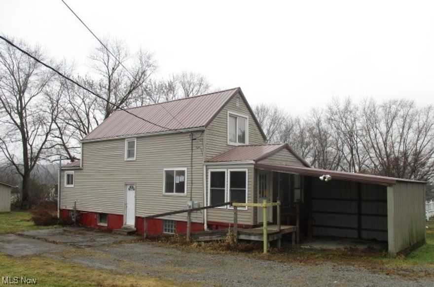 Vinyl sided 4 bedroom 2 story features a metal roof, spacious 2 car garage plus carport/storage shed located in a serene setting  convenient to all amenities.